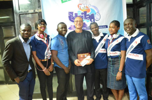 Prof Pat Utomi flanked by thr radio crew members